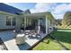 Covered backyard patio features Adirondack chairs and a patio table, perfect for outdoor entertaining at 921 Snow Prince Ln, York, SC 29745