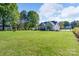 An expansive backyard features a lush green lawn that extends from the home to the tree line at 921 Snow Prince Ln, York, SC 29745