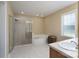 Bright bathroom featuring a soaking tub, glass-enclosed shower, and a large window at 921 Snow Prince Ln, York, SC 29745