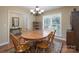 Well-lit dining room with wooden table, chairs, chandelier, and ample natural light from a window at 921 Snow Prince Ln, York, SC 29745