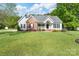 Inviting single-Gathering home showcasing manicured lawn, gray siding, and charming brick accents for classic curb appeal at 921 Snow Prince Ln, York, SC 29745