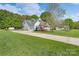 Home exterior features a long driveway, attached garage, and well-manicured lawn at 921 Snow Prince Ln, York, SC 29745