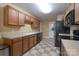 Functional kitchen space with wood cabinets, neutral countertops, and tile flooring for easy maintenance and cleaning at 921 Snow Prince Ln, York, SC 29745