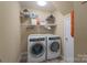 Convenient laundry room with a washer, dryer, and ample shelving for storage at 921 Snow Prince Ln, York, SC 29745