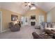 Comfortable living room featuring vaulted ceiling, fireplace, neutral carpet, ceiling fan, and comfortable seating at 921 Snow Prince Ln, York, SC 29745