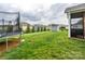 Large backyard features lush lawn space, a trampoline, storage shed, and mature trees at 10024 Fox Trotter Ln, Midland, NC 28107