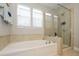 Serene bathroom featuring a separate shower and a luxurious white soaking tub with tile surround at 10024 Fox Trotter Ln, Midland, NC 28107