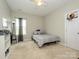 Neutral bedroom with carpet, a single bed, a window, and a basketball hoop on the door at 10024 Fox Trotter Ln, Midland, NC 28107