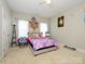 Bright bedroom featuring plush carpet, a ceiling fan, and decorated with colorful decor at 10024 Fox Trotter Ln, Midland, NC 28107
