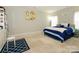 Comfortable bedroom with bright natural light, neutral carpet and blue bedding at 10024 Fox Trotter Ln, Midland, NC 28107