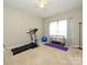 Carpeted exercise room with a treadmill, fitness ball, and weight rack by a window at 10024 Fox Trotter Ln, Midland, NC 28107
