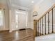 Bright foyer with beautiful door, sidelights, wooden floors, and a staircase to the upper level at 10024 Fox Trotter Ln, Midland, NC 28107