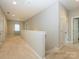 Spacious hallway on second floor with neutral carpet, white trim, and lots of natural light at 10024 Fox Trotter Ln, Midland, NC 28107