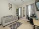 Comfortable home office space with a grey couch, black bookshelf, and stylish patterned curtains for natural light at 10024 Fox Trotter Ln, Midland, NC 28107