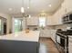 Modern kitchen with stainless steel appliances, gray island, and white cabinets at 10024 Fox Trotter Ln, Midland, NC 28107