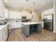 Spacious kitchen with gray island, stainless steel appliances, and ample counter space at 10024 Fox Trotter Ln, Midland, NC 28107