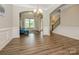 Inviting living room with wood floors, archways, and a staircase for an airy and bright atmosphere at 10024 Fox Trotter Ln, Midland, NC 28107