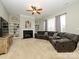 Cozy living room with a fireplace, built-in bookshelves, and a comfortable gray sectional sofa at 10024 Fox Trotter Ln, Midland, NC 28107