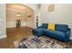 Open concept living room features wood floors, archways, and a comfortable blue couch at 10024 Fox Trotter Ln, Midland, NC 28107