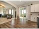 An open-concept living room flows onto a screened-in porch from the wood floored breakfast nook at 10024 Fox Trotter Ln, Midland, NC 28107
