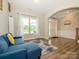 Bright and airy living room with a view, featuring wood floors and a cozy blue couch at 10024 Fox Trotter Ln, Midland, NC 28107