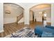 Elegant living room showcasing archways, stairs, and views into the dining room and kitchen at 10024 Fox Trotter Ln, Midland, NC 28107