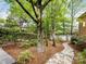Backyard walkway with stone pavers, mature trees, and lush landscaping at 10626 Newberry Park Ln, Charlotte, NC 28277