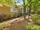Brick house exterior with screened in porch, brick patio and walkway, and mature trees at 10626 Newberry Park Ln, Charlotte, NC 28277