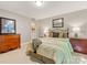 Cozy bedroom featuring neutral walls, carpet, and stylish furnishings with comfortable queen size bed at 10626 Newberry Park Ln, Charlotte, NC 28277
