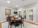 Elegant dining room featuring a round wooden table, chandelier, and a view of the outdoors at 10626 Newberry Park Ln, Charlotte, NC 28277