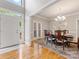 Inviting dining room with hardwood floors, elegant chandelier, and a doorway leading to the outside at 10626 Newberry Park Ln, Charlotte, NC 28277