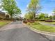 Community entrance with brick sign, mature landscaping, and wrought iron gate at 10626 Newberry Park Ln, Charlotte, NC 28277