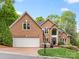 Charming brick home featuring a two-car garage, manicured lawn, and beautiful landscaping at 10626 Newberry Park Ln, Charlotte, NC 28277