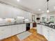 Well-equipped kitchen with granite countertops, white cabinets, modern appliances, and hardwood flooring at 10626 Newberry Park Ln, Charlotte, NC 28277