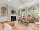 Bright living room with built-in shelves, fireplace, large windows with shutters, and comfortable sofas at 10626 Newberry Park Ln, Charlotte, NC 28277