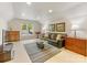 Spacious living room featuring a leather sofa, wooden furniture, and a window view at 10626 Newberry Park Ln, Charlotte, NC 28277