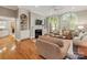 Spacious living room featuring hardwood floors, fireplace, built-in shelves, and plenty of natural light at 10626 Newberry Park Ln, Charlotte, NC 28277