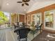 Cozy screened-in porch featuring brick accents and comfortable wicker furniture at 10626 Newberry Park Ln, Charlotte, NC 28277