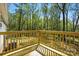 A wood deck that overlooks a grassy backyard area with mature trees and shade at 110 Matthew Dr, Kings Mountain, NC 28086
