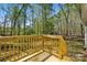 A wood deck that overlooks a grassy backyard area with mature trees and shade at 110 Matthew Dr, Kings Mountain, NC 28086