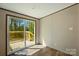 Bedroom with wood-look flooring, sliding glass doors to the deck, base molding, and crown molding at 110 Matthew Dr, Kings Mountain, NC 28086