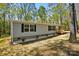 Charming single-story home featuring gray siding, black shutters and a small wooden porch at 110 Matthew Dr, Kings Mountain, NC 28086