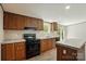 Bright kitchen features wood cabinets, island with countertop, and black appliances at 110 Matthew Dr, Kings Mountain, NC 28086