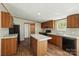 Bright kitchen boasts wood cabinets, island with countertop, and black appliances at 110 Matthew Dr, Kings Mountain, NC 28086
