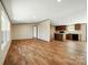 Open living space with hardwood floors seamlessly connects to a kitchen with dark cabinets at 110 Matthew Dr, Kings Mountain, NC 28086