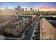 Stunning aerial view of townhomes with city skyline backdrop, showcasing the neighborhood layout at 11039 Stetler St, Charlotte, NC 28204
