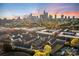 Stunning aerial view of townhomes with the Charlotte skyline in the background at sunset at 11039 Stetler St, Charlotte, NC 28204