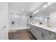 Modern bathroom featuring double sinks, a glass shower, and a large mirror at 11039 Stetler St, Charlotte, NC 28204