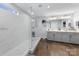Bright bathroom with marble-look tile, a glass shower, and double vanity at 11039 Stetler St, Charlotte, NC 28204