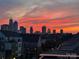 Sunset view from rooftop with colorful orange and red skyline above townhouses at 11039 Stetler St, Charlotte, NC 28204